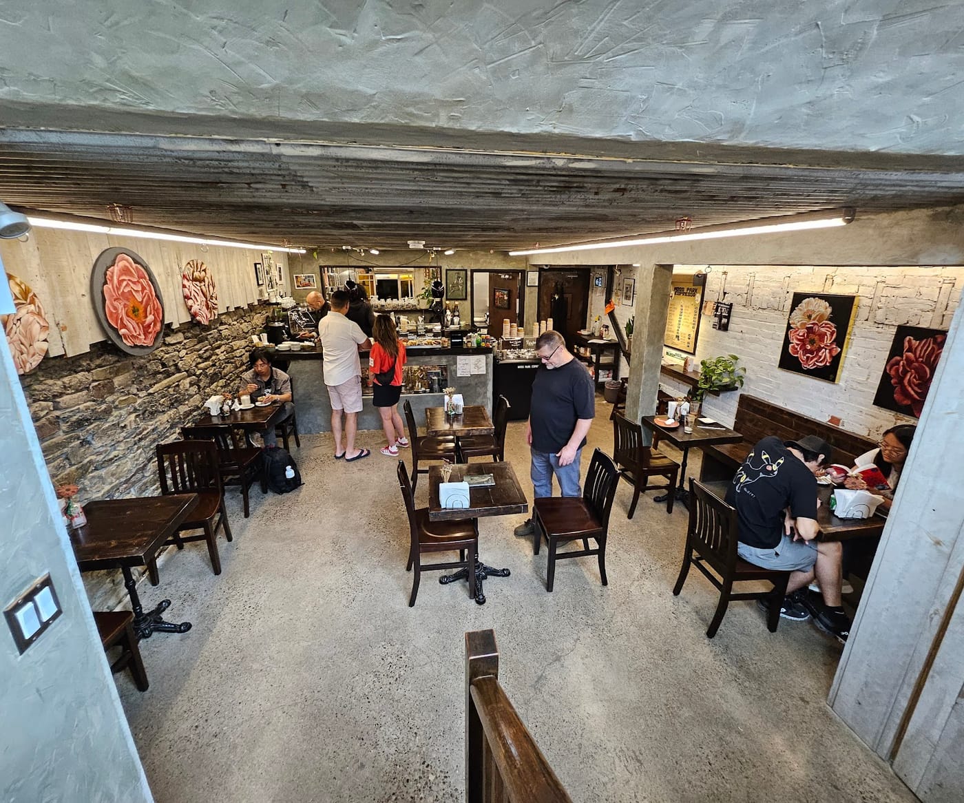 The room below street level, fieldstone wall and painted peonies
